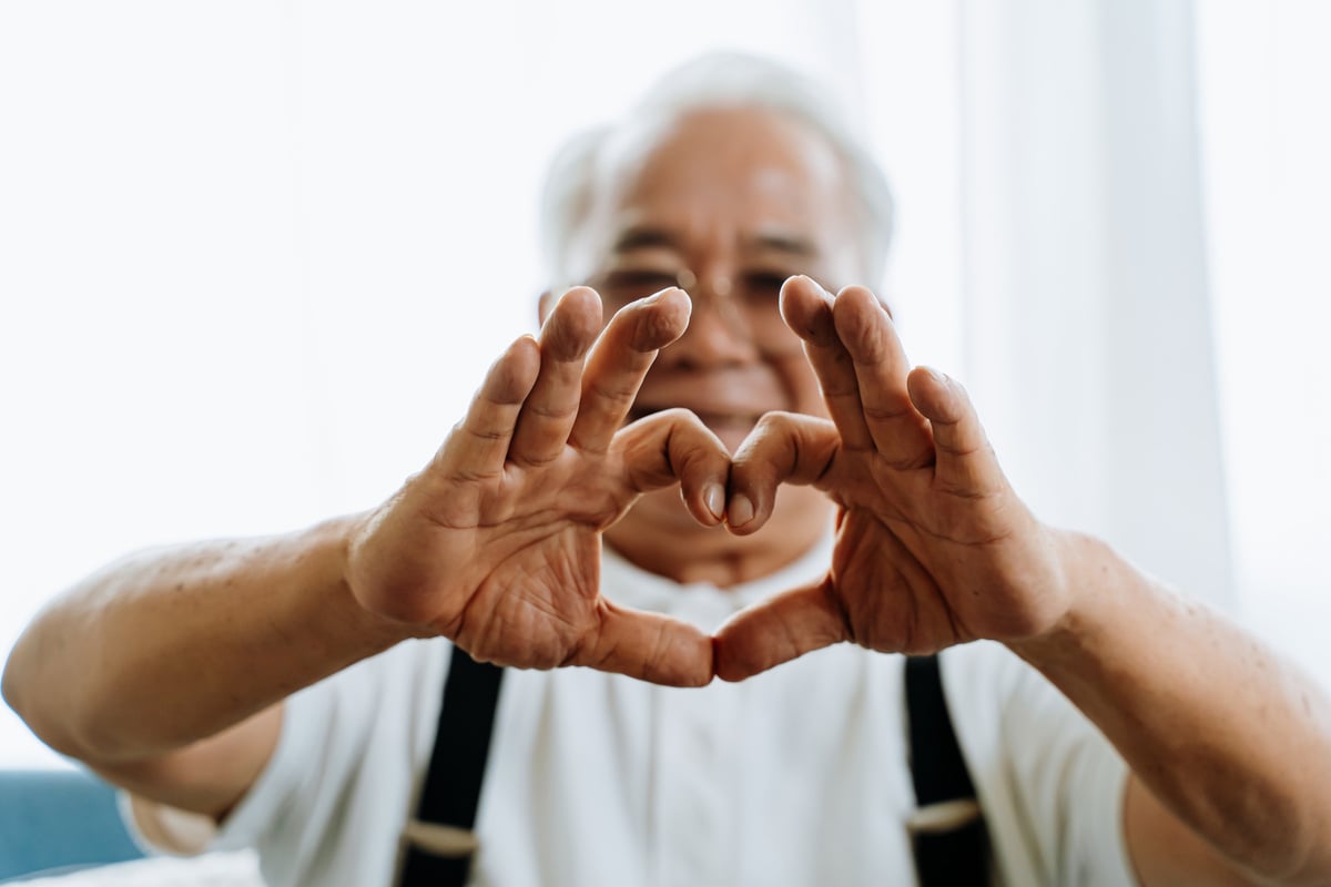 Elderly Man Making a Hand Heart